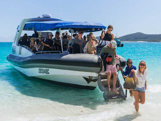 Guests departing off zigzag on whitehaven beach