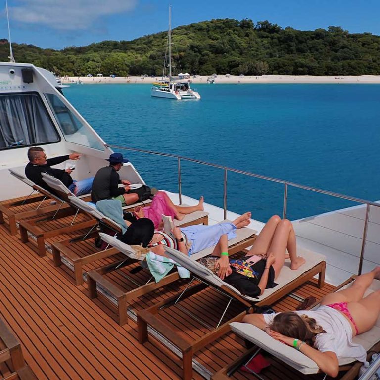 Super-flyer-top-deck Top sun deck on super flyer with whitehaven beach in background