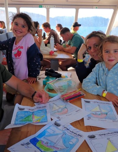 Family using the colouring in sets onboard zigzag whitsundays