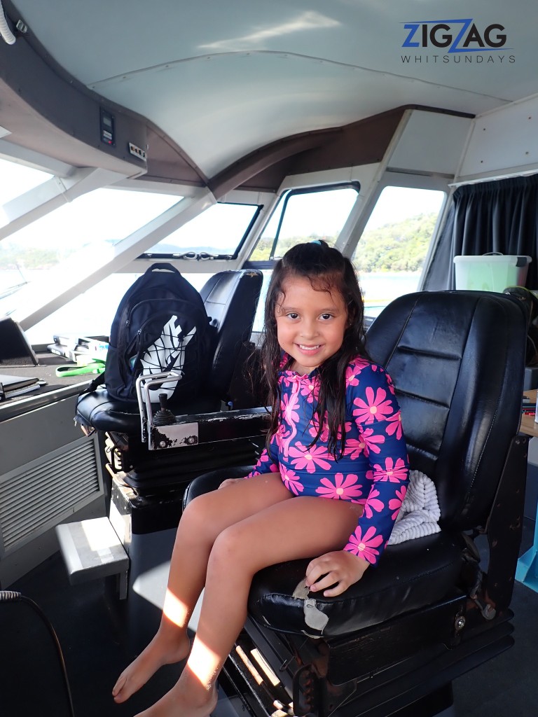 Travelling with children on zigzag whitsundays (14) (medium) Child sitting in the captains chair