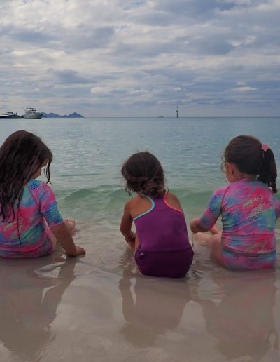 3 kids at the waters edge on whitehaven beach