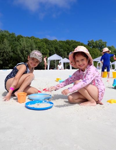 Kids making sandcastles at whitehaven beach on whitsunday island