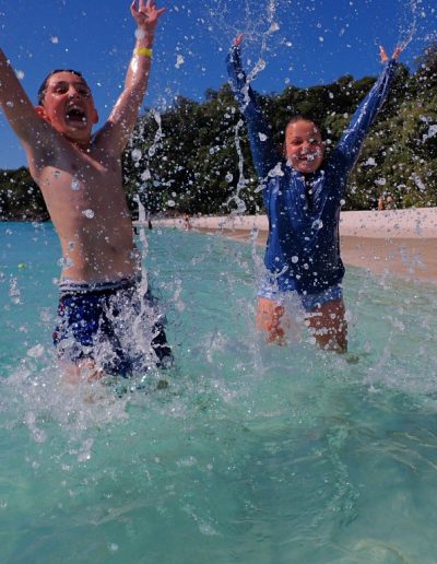 Kids playing in the water at whitsunday island