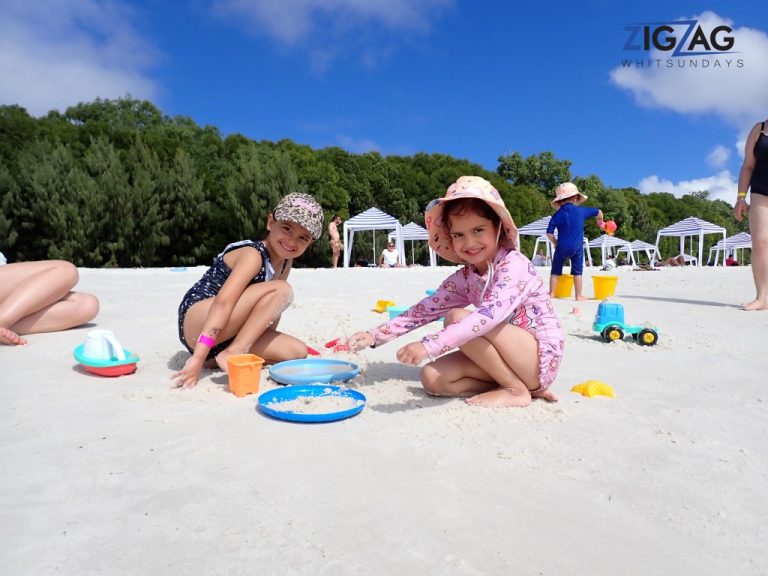 Family playing in the sands of whitehaven on whitsunday island