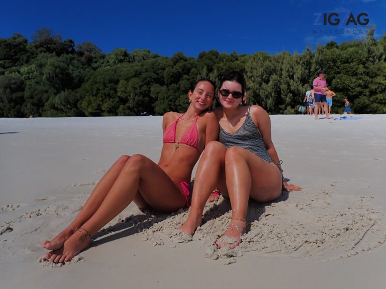 2 friends sunbaking on whitehaven beach