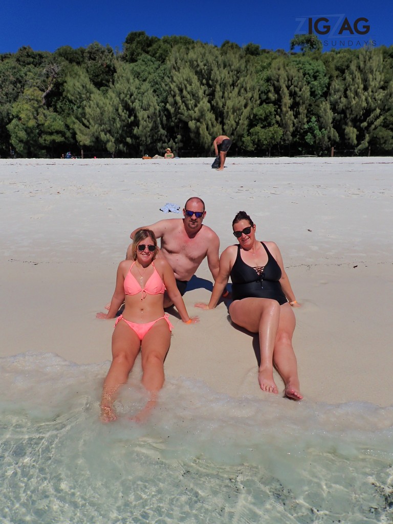 3 zigzag whitsundays day tour guests enjoying a beautiful day at whitehaven beach