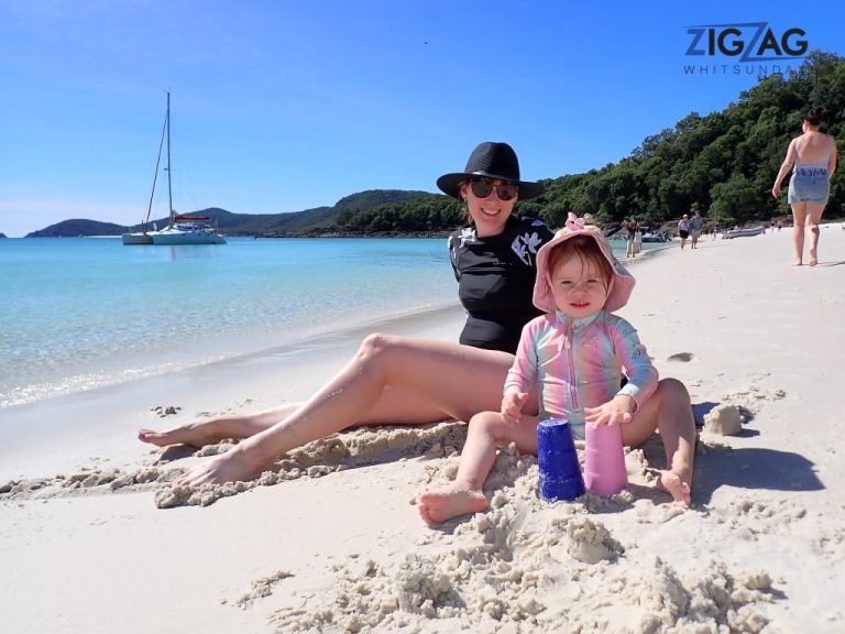 Mum and daughter playing in the sand