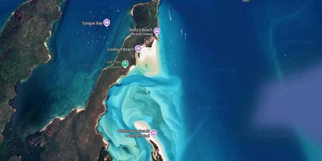 Satellite image of whitsunday island showing whitehaven bay/bettys beach as a small separate beach in the top right, the hill inlet tidal channel in the middle, and the long main whitehaven beach running down the bottom of the frame, with the two beaches clearly separated by the inlet